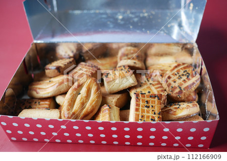 close up of sweet cookies in a packet on table  112166909