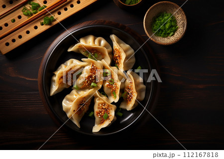 Grilled dumplings meat gyoza in black plate with soy sauce 112167818