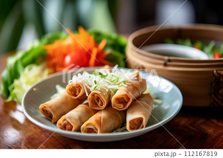 Golden baked empanadas on dark surface with spices scattered around. 112167819