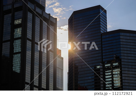 Skyscraper glass facades on a bright sunny day with sunbeams Jan 13 2024 112172921