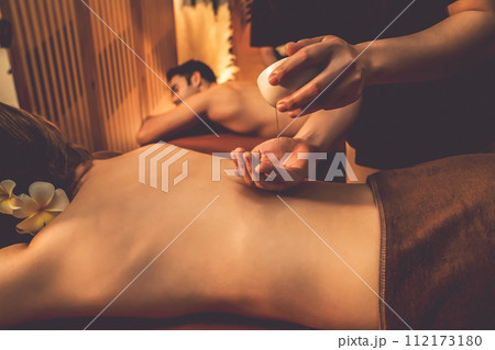 Masseuse prepare oil massage procedure for couple customer at spa. Quiescent Masseuse prepare oil massage procedure for couple customer at spa. Quiescent 112173180