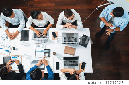 Analyst team utilizing BI Fintech to analyze financial data at table. Prudent 112173274