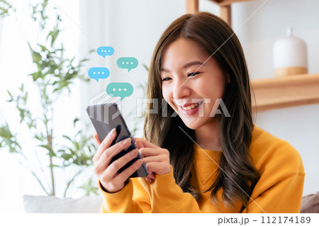 Adorable young Asian woman using mobile smartphone Adorable young Asian woman using mobile smartphone 112174189