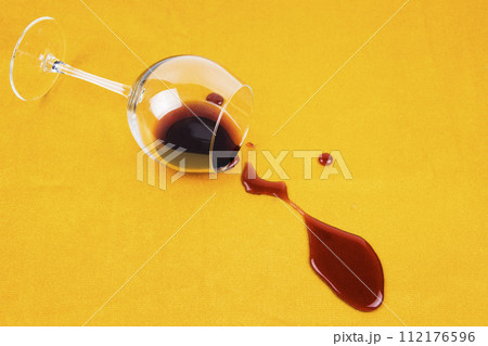 a spilled glass of wine on the tablecloth. Cleaning clothes and furniture from stains. a spilled glass of wine on the tablecloth. Cleaning clothes and furniture from stains. 112176596