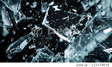 Large shards of broken glass fly towards the camera in slow motion with high contrast, cinematic lighting. Hyper-realistic. 112178638