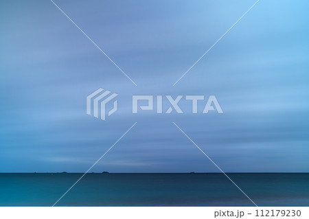 Diminutive Islands on the Horizon of Stormy Seascape with Long Exposure Diminutive Islands on the Horizon of Stormy Seascape with Long Exposure 112179230