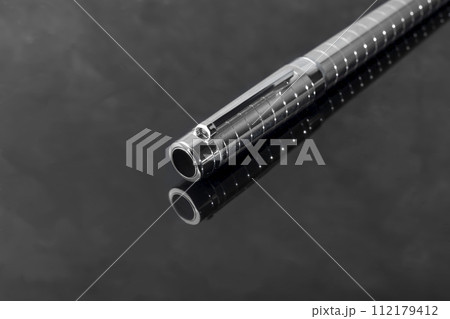 Fountain pen on marble and gray background with reflection. Vibration focus. Fountain pen on marble and gray background with reflection. Vibration focus. 112179412