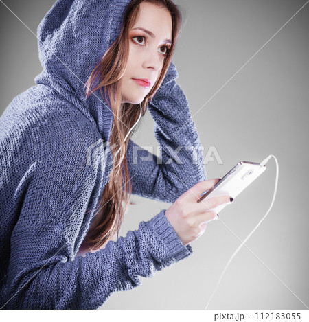 young woman with smart phone listening music young woman with smart phone listening music 112183055