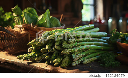 Fresh green asparagus and organic vegetables on a rustic old wooden table 112184079