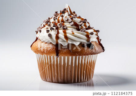 A delectable caramel drizzled cupcake with creamy frosting. 112184375