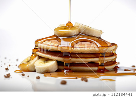 Stack of pancakes with maple syrup and banana slices. 112184441