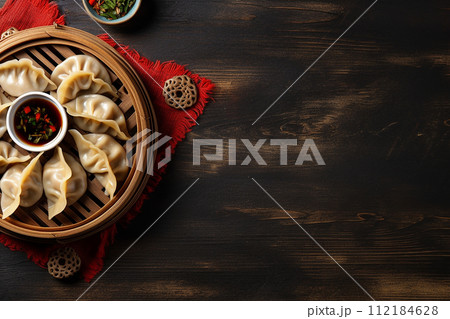Steamed dumplings meat gyoza on a round plate with soy sauce and chopsticks 112184628