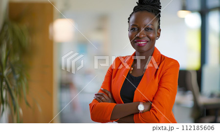 Portrait of a businesswoman with confident and friendly facial expression and her arms crossed in front of blurred office background. Generative AI Portrait of a businesswoman with confident and friendly facial expression and her arms crossed in front of blurred office background. Generative AI 112185606