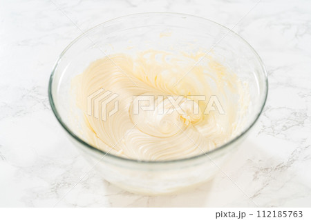 Preparing cream cheese frosting to ice the delicious pumpkin bundt cake. Preparing cream cheese frosting to ice the delicious pumpkin bundt cake. 112185763