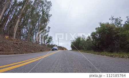 In this serene winter scene, a vehicle carefully makes its way along Los Osos Valley Road and Pecho Valley Road within Montana de Oro State Park. 112185764