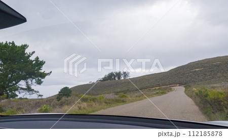In this serene winter scene, a vehicle carefully makes its way along Los Osos Valley Road and Pecho Valley Road within Montana de Oro State Park. 112185878