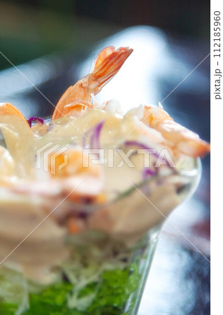 Glass with shrimp cocktail in white sauce Glass with shrimp cocktail in white sauce 112185960