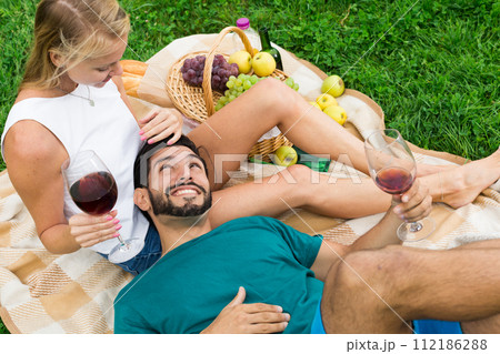 Man is lying on the lap of girlfriend in time picnic 112186288
