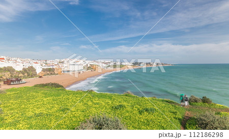 Wide sandy beach and Atlantic ocean in city of Albufeira timelapse. Algarve, Portugal Wide sandy beach and Atlantic ocean in city of Albufeira timelapse. Algarve, Portugal 112186298