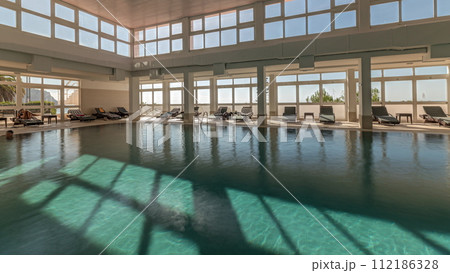 Panorama showing luxury indoor swimming pool, part of hotel timelapse 112186328