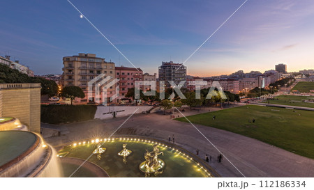 Panorama showing lawn at Alameda Dom Afonso Henriques and the Luminous Fountain aerial day to night timelapse in Lisbon. Panorama showing lawn at Alameda Dom Afonso Henriques and the Luminous Fountain aerial day to night timelapse in Lisbon. 112186334