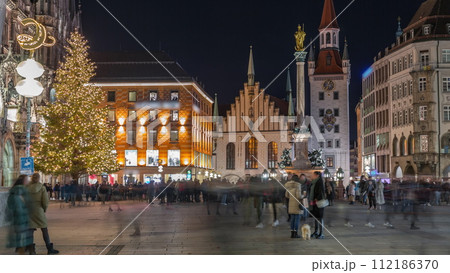 Marienplatz with the old Munich town hall and the Talburg Gate night timelapse, Bavaria, Germany. 112186370