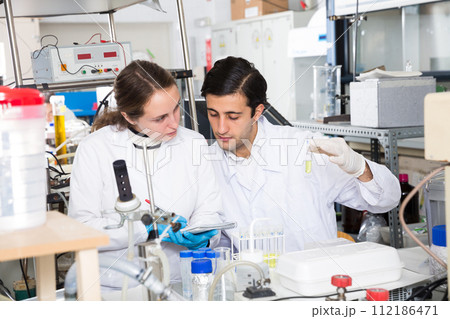 Scientists writing report on chemical experiments 112186471