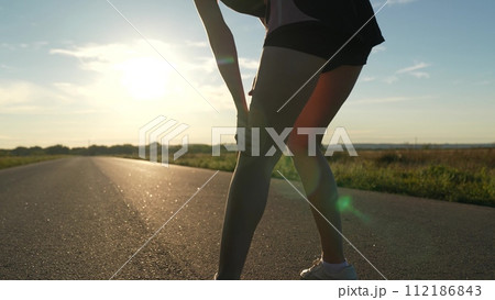 silhouette sports girl running along road sunset, legs close-up, professional athletes, stretching body, woman runs, motivation running with fitness woman, triathlon exercise, profile exercises silhouette sports girl running along road sunset, legs close-up, professional athletes, stretching body, woman runs, motivation running with fitness woman, triathlon exercise, profile exercises 112186843