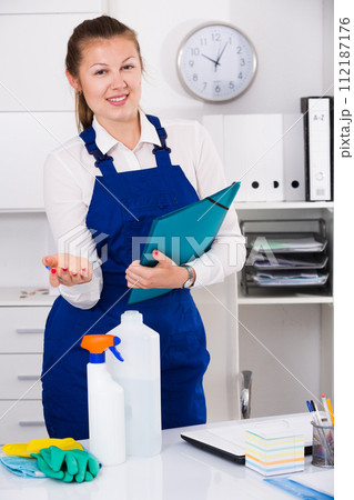 House worker woman is signing documents while cleaning House worker woman is signing documents while cleaning 112187176