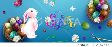 Blue card with Easter eggs in a nest, a beautiful pink bunny 112187642
