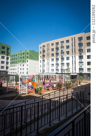 Residential buildings with a playground in the courtyard 112189262