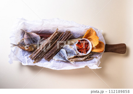 Top view of assorted dry fish for beer. fish on a wooden board Top view of assorted dry fish for beer. fish on a wooden board 112189858