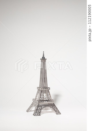 Delicate metal Eiffel Tower model on white background Delicate metal Eiffel Tower model on white background 112190005