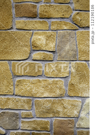 Detail of cladding and decoration on a wall outside 112190186