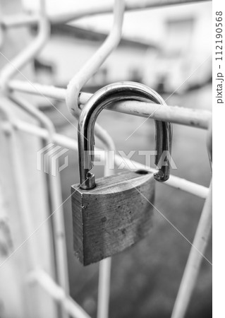 Padlock on a fence Padlock on a fence 112190568