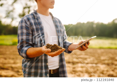 Gardening or ecology concept. Farmer's hands collects soil and checks its health before growing crop 112191840