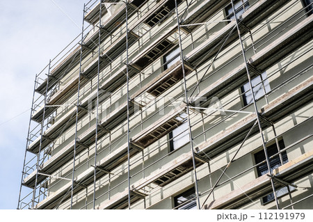 Reconstruction of an old house. Scaffolding for construction, construction site. Selective focus Reconstruction of an old house. Scaffolding for construction, construction site. Selective focus 112191979