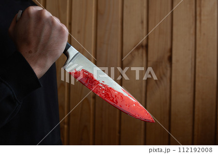 Bloody knife in hand with reverse grip Bloody knife in hand with reverse grip 112192008