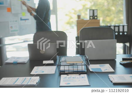 Laptop on a desk in an open financial office. 112192010