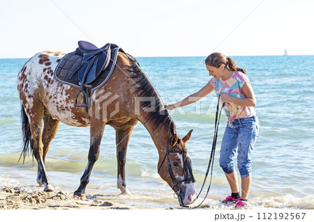 woman and appaloosa horse 112192567