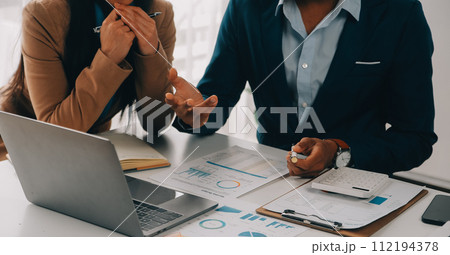 Business team working with new startup project plan and discussion information for financial strategy with laptop and digital tablet in a modern business lounge. Business team working with new startup project plan and discussion information for financial strategy with laptop and digital tablet in a modern business lounge. 112194378