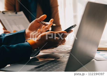 Business team working with new startup project plan and discussion information for financial strategy with laptop and digital tablet in a modern business lounge. 112194397