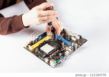 Technological background with closeup on tester checking motherboard. Technological background with closeup on tester checking motherboard. 112194776