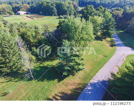 Aerial View of Serene Rural Landscape with Red Barn and Garden Path 112196273