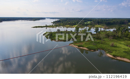 Aerial Serene River and Lush Greenery with Buoy Line 112196419