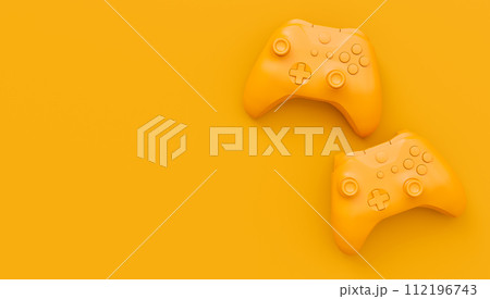 Video game joysticks or gamepads in plain monochrome yellow color background 112196743