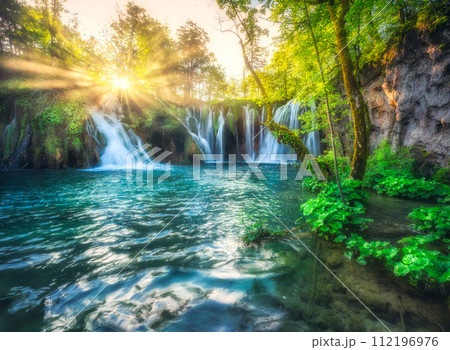 Waterfall in green forest in Plitvice Lakes, Croatia at sunset Waterfall in green forest in Plitvice Lakes, Croatia at sunset 112196976