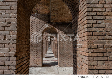 Endless brick passage with repeating archways in Fort Jefferson on Dry Tortugas National Park. Endless brick passage with repeating archways in Fort Jefferson on Dry Tortugas National Park. 112197058