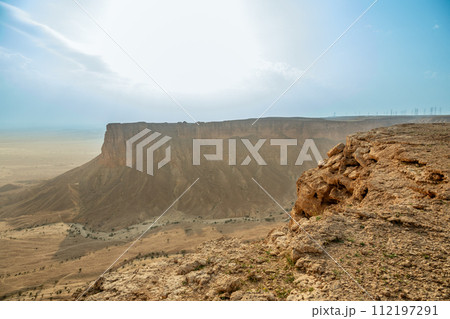 The Jabal Tuwaiq Mountains, with arid desert below, landscape panorama, Riyadh, Saudi Arabia 112197291