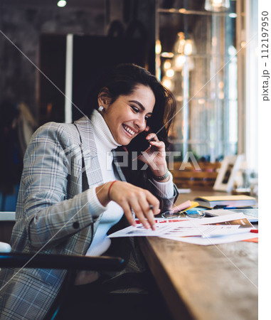 Cheerful remote worker calling on mobile creating project Cheerful remote worker calling on mobile creating project 112197950